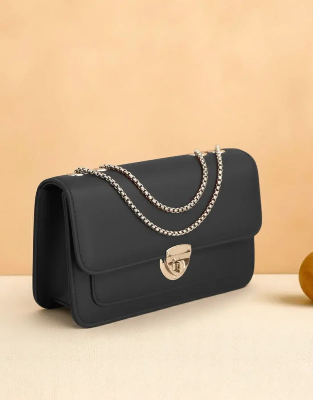 Sleek black vegan leather crossbody bag with gold twist-lock closure for women and teens